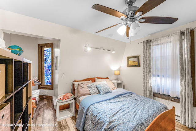 bedroom with ceiling fan and wood-type flooring