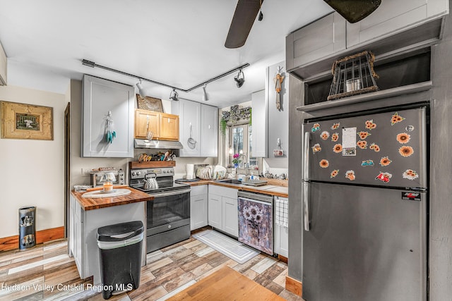 kitchen featuring light hardwood / wood-style floors, white cabinetry, wooden counters, and appliances with stainless steel finishes