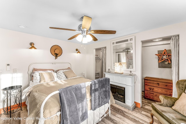 bedroom with a closet, ceiling fan, and light hardwood / wood-style flooring