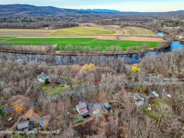 drone / aerial view featuring a rural view and a water and mountain view