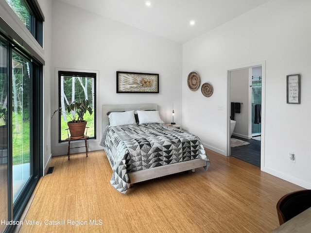 501 Birch St, Copake, NY 12516 - bedroom featuring multiple windows, wood finished floors, a high ceiling, recessed lighting, and ensuite bathroom