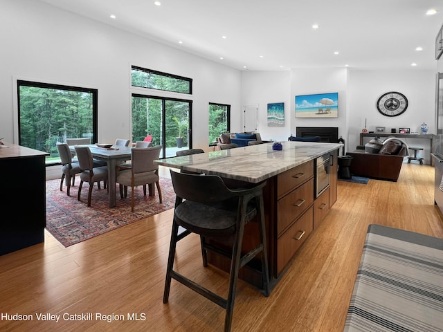 501 Birch St, Copake, NY 12516 - kitchen featuring recessed lighting, a kitchen island, light wood-style flooring, light stone countertops, and open floor plan
