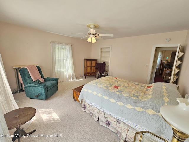 bedroom featuring ceiling fan and carpet