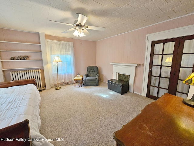 bedroom with ceiling fan, radiator heating unit, and carpet floors