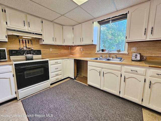 kitchen featuring white appliances, white cabinetry, a paneled ceiling, and sink