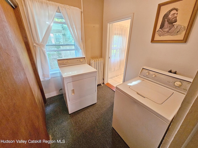 laundry area with dark colored carpet, radiator heating unit, and washing machine and clothes dryer