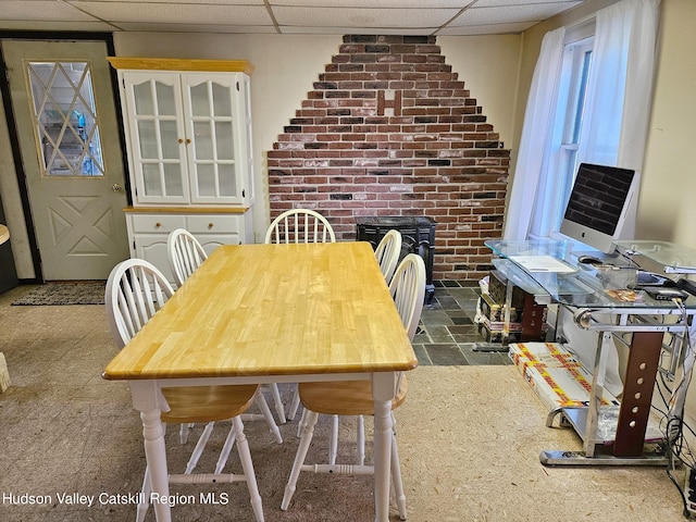 dining area featuring a drop ceiling