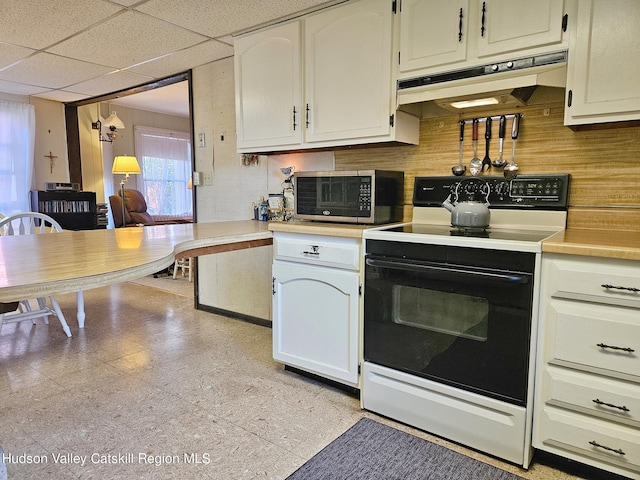 kitchen with electric stove, a paneled ceiling, and white cabinets