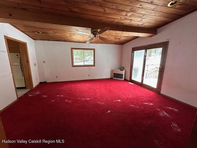 empty room featuring wooden ceiling, carpet flooring, vaulted ceiling with beams, and ceiling fan