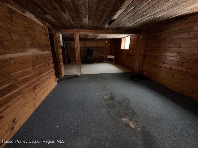 basement with wood ceiling and wooden walls