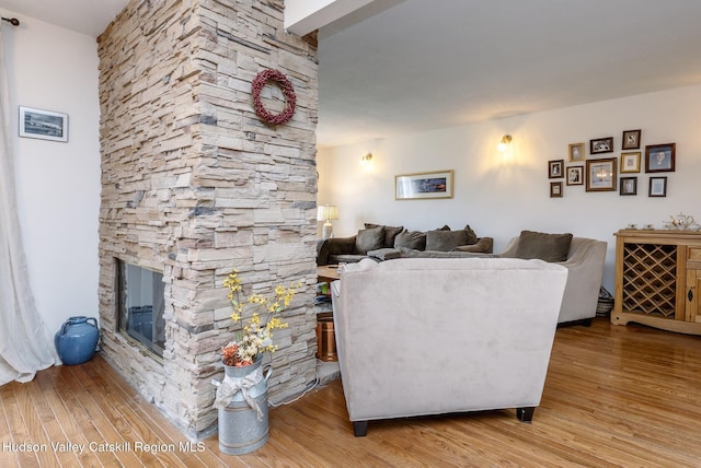 217 Aspen Ter, Poughkeepsie, NY 12601 - living room with a stone fireplace and wood finished floors