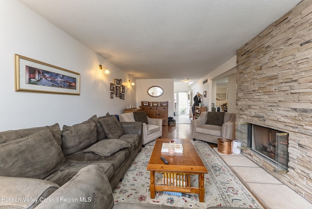217 Aspen Ter, Poughkeepsie, NY 12601 - living room featuring a textured ceiling, a fireplace, and wood finished floors