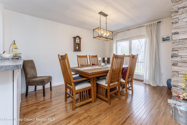 217 Aspen Ter, Poughkeepsie, NY 12601 - dining area with light wood finished floors, baseboards, and a notable chandelier