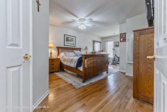 217 Aspen Ter, Poughkeepsie, NY 12601 - bedroom with a textured ceiling, wood finished floors, and baseboards