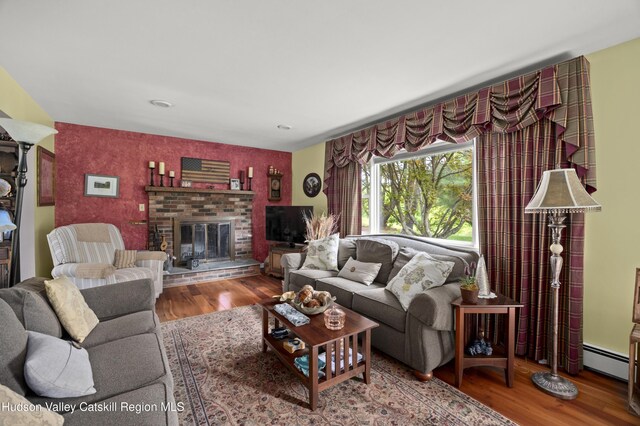 2727 County Route 8, Elizaville, NY 12523 - living room with wood finished floors, a baseboard radiator, and a fireplace