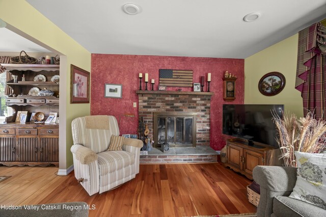 2727 County Route 8, Elizaville, NY 12523 - living area with an accent wall, wood finished floors, and a fireplace