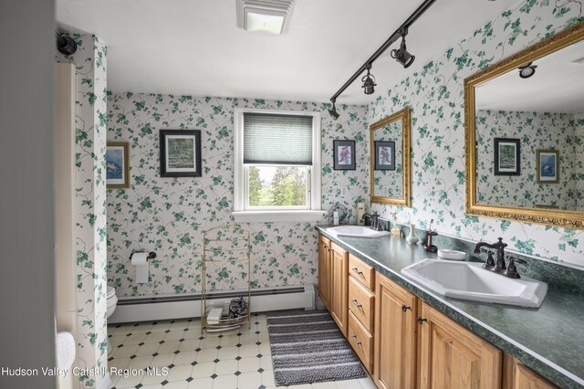 2727 County Route 8, Elizaville, NY 12523 - full bathroom featuring wallpapered walls, double vanity, baseboard heating, toilet, and tile patterned floors