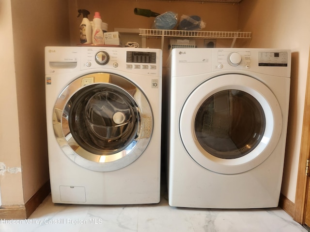 2773 Lucas Tpke, Accord, NY 12404 - washroom with washer and clothes dryer, baseboards, and light marble finish flooring