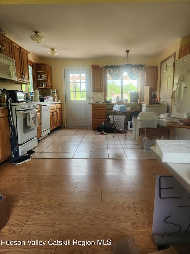 2773 Lucas Tpke, Accord, NY 12404 - kitchen featuring white appliances, open shelves, brown cabinetry, and hanging light fixtures