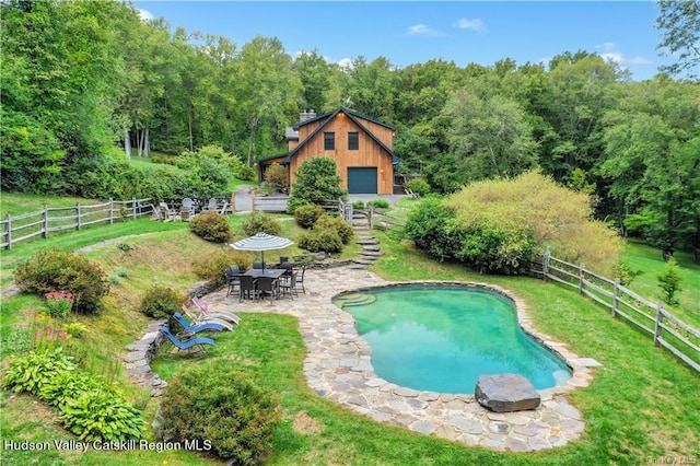 view of swimming pool featuring a yard and a patio