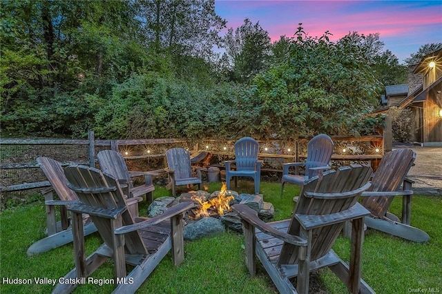 yard at dusk featuring a fire pit