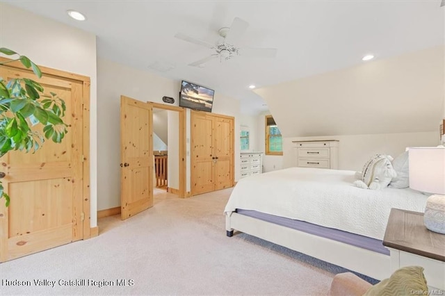 carpeted bedroom featuring ceiling fan and lofted ceiling