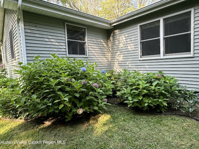 view of property exterior with a lawn