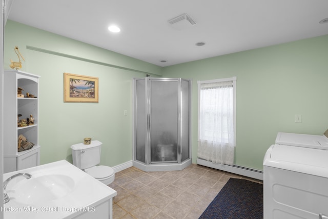 2410 Bruynswick Rd, Wallkill, NY 12589 - bathroom featuring washing machine and clothes dryer, a baseboard heating unit, a sink, a shower stall, and toilet