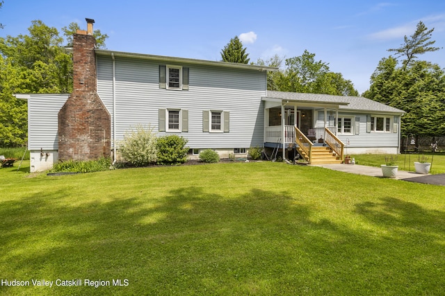 2410 Bruynswick Rd, Wallkill, NY 12589 - view of front facade with a chimney, a front yard, and a porch