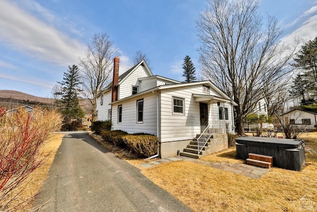 51 Division St, Hunter, NY 12442 - view of front of property featuring a hot tub and a chimney