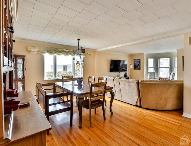 51 Division St, Hunter, NY 12442 - dining area featuring crown molding, light wood-style flooring, and a chandelier