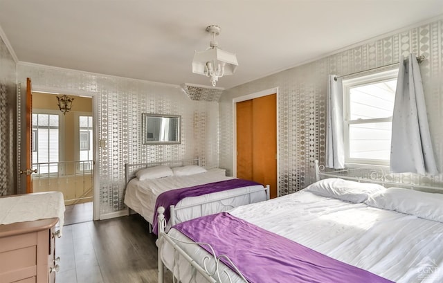 51 Division St, Hunter, NY 12442 - bedroom with wallpapered walls, wood finished floors, ornamental molding, baseboards, and a chandelier