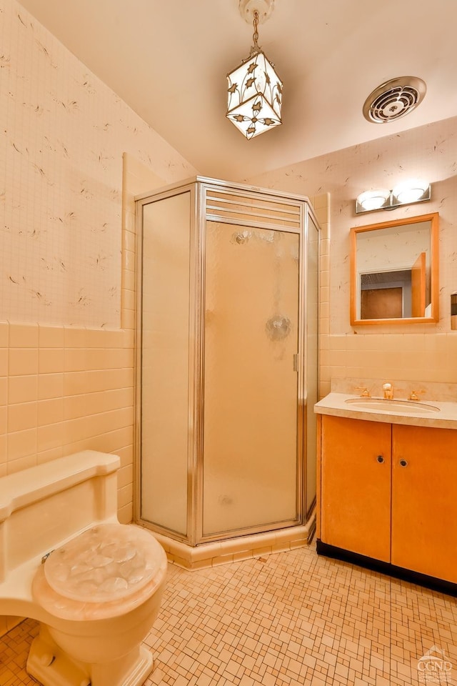 51 Division St, Hunter, NY 12442 - bathroom with tile walls, a shower stall, vanity, and toilet