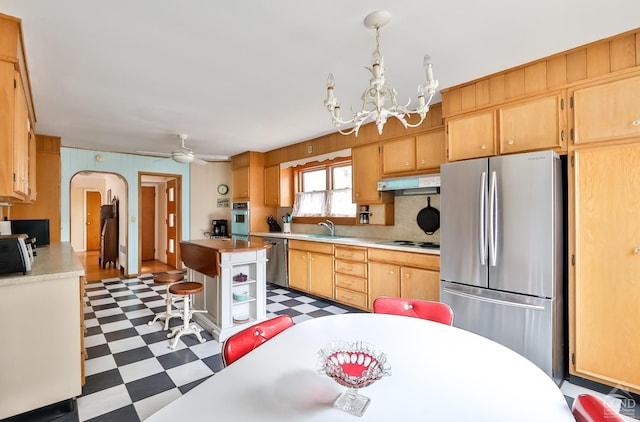 51 Division St, Hunter, NY 12442 - kitchen with stainless steel appliances, light flooring, under cabinet range hood, a sink, and light countertops