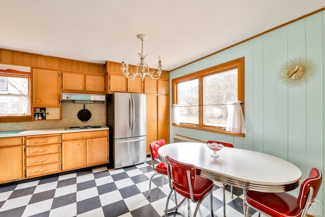 51 Division St, Hunter, NY 12442 - kitchen with freestanding refrigerator, a chandelier, dark flooring, and healthy amount of natural light