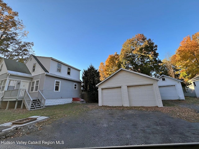 view of side of property featuring a garage and an outbuilding