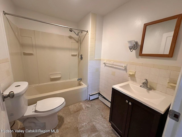 full bathroom with vanity, toilet, baseboard heating, and tile walls