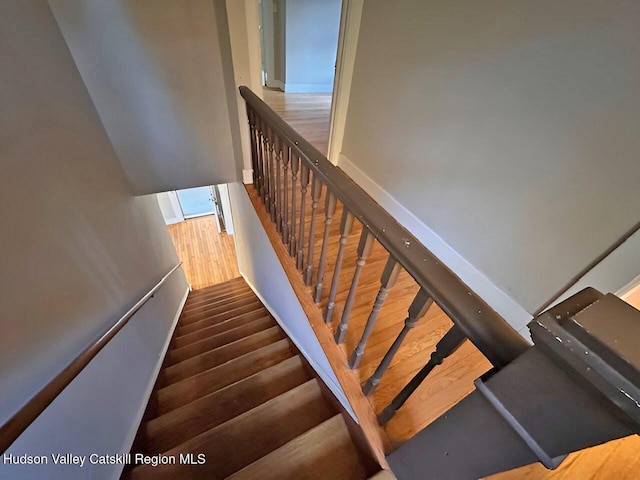 staircase featuring hardwood / wood-style floors