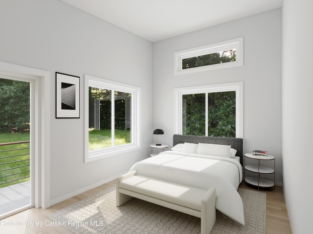 bedroom featuring light wood-type flooring and access to outside