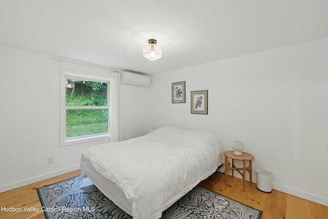 200 Wilbur Ave, Kingston, NY 12401 - bedroom with an AC wall unit, wood finished floors, and baseboards