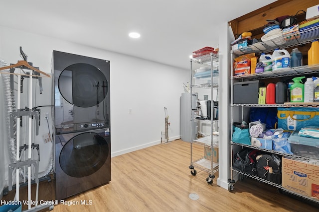 200 Wilbur Ave, Kingston, NY 12401 - washroom with estacked washer and dryer, wood finished floors, baseboards, and water heater