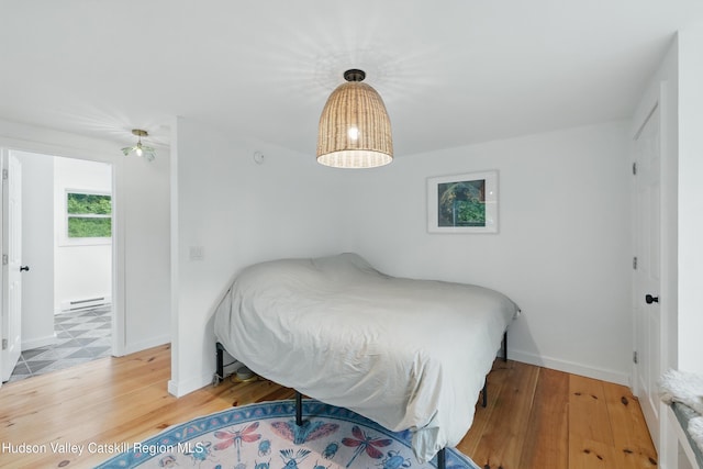 200 Wilbur Ave, Kingston, NY 12401 - bedroom featuring baseboard heating, wood finished floors, and baseboards