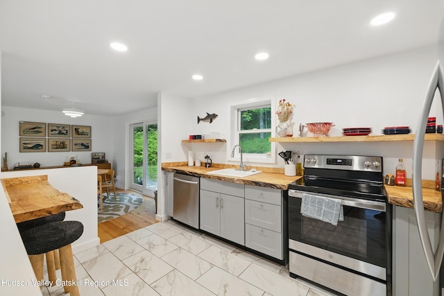 200 Wilbur Ave, Kingston, NY 12401 - kitchen featuring appliances with stainless steel finishes, a sink, open shelves, plenty of natural light, and recessed lighting