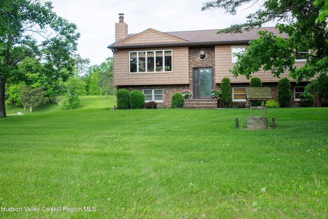 526 Taghkanic Rd, Elizaville, NY 12523 - raised ranch featuring a chimney, a front yard, and brick siding