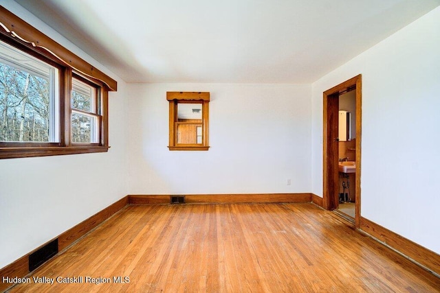 spare room featuring light hardwood / wood-style floors