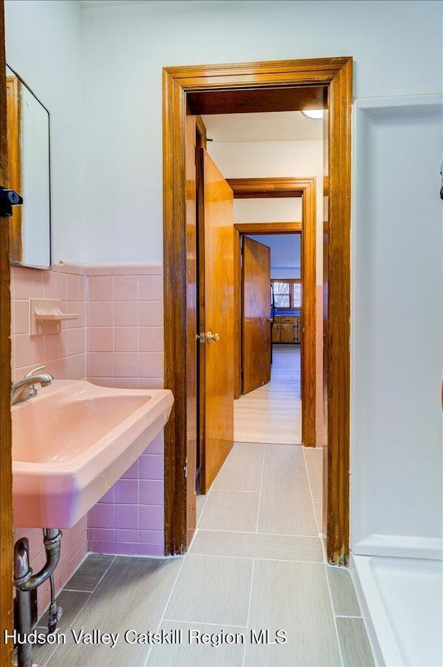 bathroom featuring tile patterned floors and tile walls