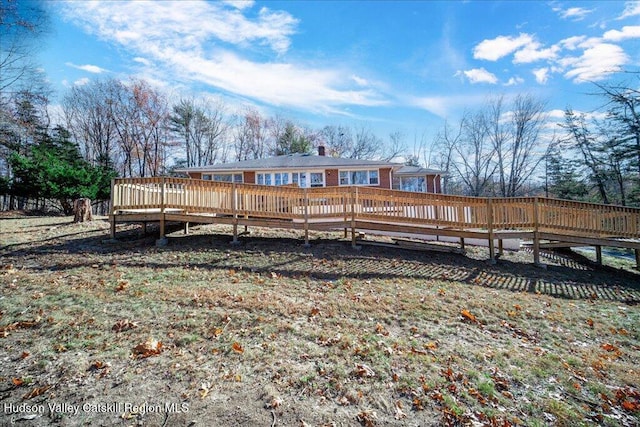 back of property with a wooden deck