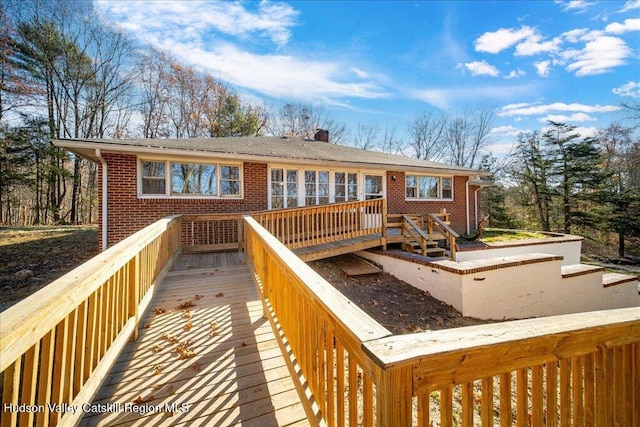 rear view of house featuring a wooden deck