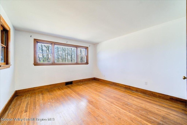 unfurnished room featuring hardwood / wood-style flooring