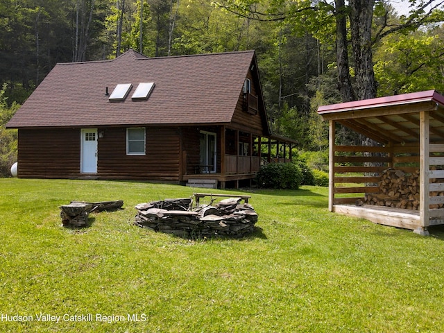 422 Waterview Dr, Andes, NY 13731 - view of front facade with a fire pit, roof with shingles, a front yard, and a wooded view